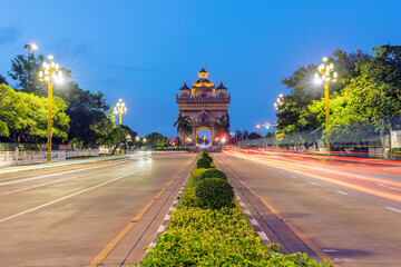 A traffic in front of Pratuxai( war monument)at dusk in Vientiane, Laos.