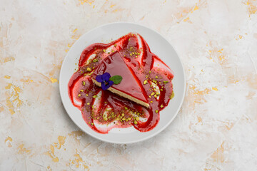 dessert strawberry cheesecake in a plate with jam on a white background
