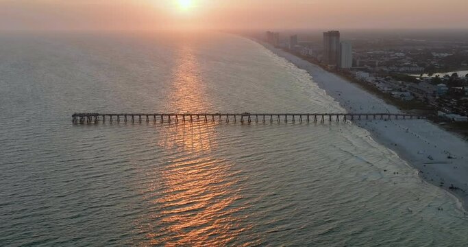 Flying towards sunset above Panama City Beach pier, Gulf of Mexico, Florida	