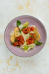 salad with salmon and bruschetta in a serene plate vertical photo
