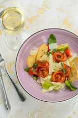 salad with salmon and bruschetta in a serene plate on a white background with a glass of wine vertical photo
