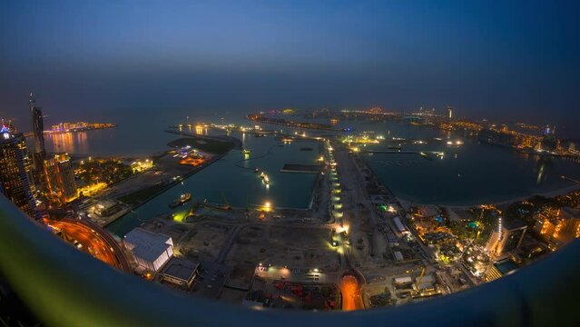 Sunset time lapse , overlook Palm jumeirah man-made island and blue water with traffic and construction 