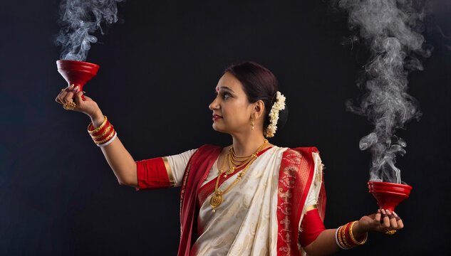 Portrait of Bengali woman holding a dhunuchi