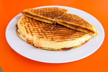 Turkish toast, mixed toast with cheddar cheese, sausage and ham, with fried potatoes (Turkish name; Bazlama Karisik tost)