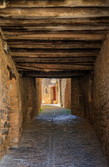 Fototapeta na wymiar Old narrow stone passage in Ujue, medieval village in Basque Country, Spain