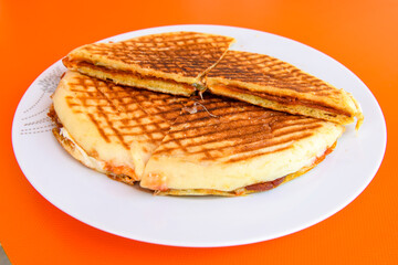 Turkish toast, mixed toast with cheddar cheese, sausage and ham, with fried potatoes (Turkish name; Bazlama Karisik tost)