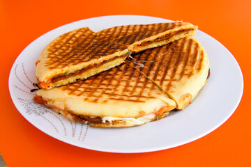 Turkish toast, mixed toast with cheddar cheese, sausage and ham, with fried potatoes (Turkish name; Bazlama Karisik tost)