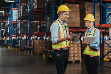 Warehouse Workers Checking Stock with digital Tablet in Logistic center. Caucasian Managers wearing safety vests to working about shipment in storehouse, Working in Storage Distribution Center.