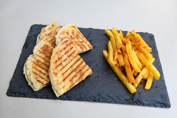 Turkish toast, mixed toast with cheddar cheese, sausage and ham, with fried potatoes (Turkish name; Bazlama Karisik tost)