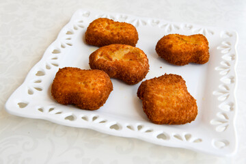 Fried Chicken breast hot crispy strips crunchy chicken tenders  isolated on white background.Nuggets isolated on white background on a plate