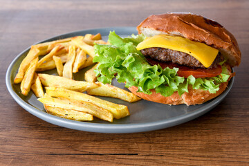 Big tasty burger with beef cutlet on a plate