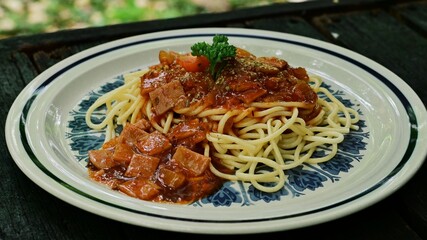 Pasta with Ham and Tomato Sauce  on the wood table. Close up.