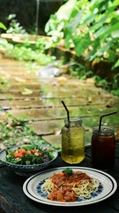 Pasta with Ham and Tomato Sauce and Japanese crab salad, Mulberry leaf tea and ice Americano Side view.