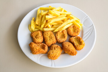 Fried Chicken breast hot crispy strips crunchy chicken tenders  isolated on white background.Nuggets isolated on white background on a plate