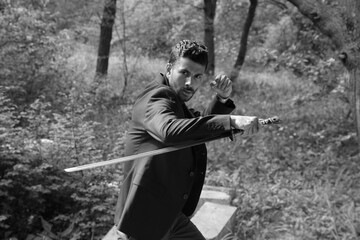 Fighter with a sword in the forest in black and white