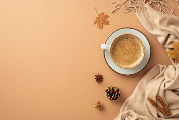 Autumn aesthetic concept. Top view photo of cup of cocoa on saucer yellow maple leaves cinnamon sticks anise pine cones and scarf on isolated beige background