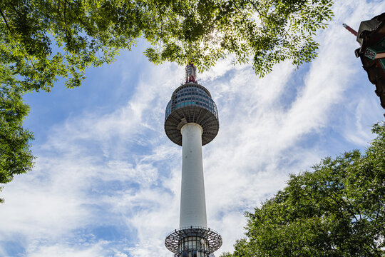 An image of beautiful Seoul tower and trees, blue sky, and clouds in Seoul, South Korea