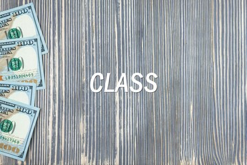 CLASS - word (text) on wooden background, money, dollars. Business concept (copy space).