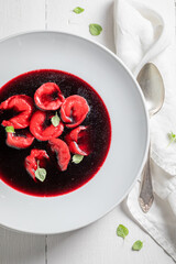 Homemade and hot beetroot soup seasoned with marjoram.