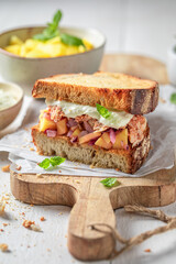 Tasty and fresh sandwich with chicken, fruits, herbs and onion.