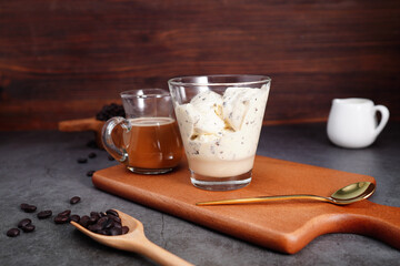 coffee drink and vanilla ice cream in a mug, coffee beans, on a rustic wooden table. 'Affogato' Italian-style dessert (spot focus)

