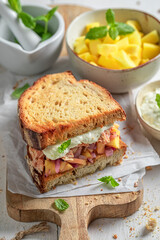 Delicious and sweet sandwich with exotic fruits, chicken and herbs.