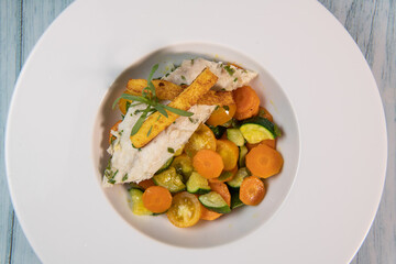 Fish recipe, fillet of sea bass with small vegetables, High quality photo