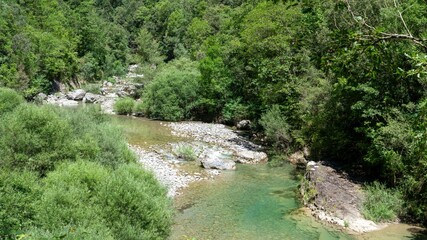 an emerald coloured river winds through a rocky gorge, the Anisclo Canyon, Ordesa National Park, Aragon Spain