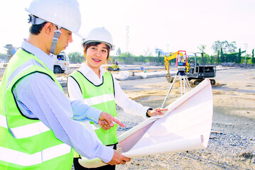 Engineer construction standing see plan paper at the construction site. - 521611982
