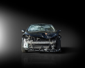 Frontal view of a black crashed car wreck - dented bonnet, smashed engine and broken windshield -...