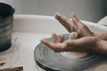 work in a pottery workshop. close-up of hands and potter's wheel