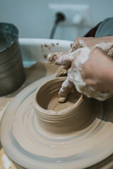 work in a pottery workshop. close-up of hands and potter's wheel