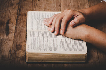 Close up of christian woman hand on holy bible are pray and worship for thank god in church with...
