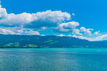 Fototapeta na wymiar Germany, Beautiful panorama view above lakeside of turquoise bodensee lake water at austrian coast at bregenz pfaender mountain