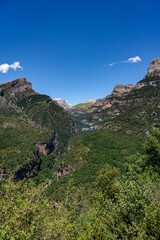 forested canyon and gorge in a mountain range, the Anisclo Canyon, Ordesa National Park, Aragon Spain, blue sky