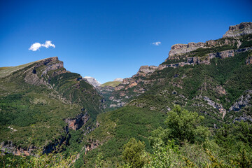 Fototapeta na wymiar forested canyon and gorge in a mountain range, the Anisclo Canyon, Ordesa National Park, Aragon Spain, blue sky