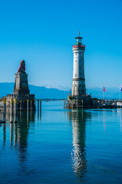 Germany, Lindau harbour lighthouse and beautiful view to austrian alps  early in the morning after sunrise