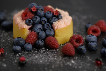 Cake with cream covered with juicy berries.