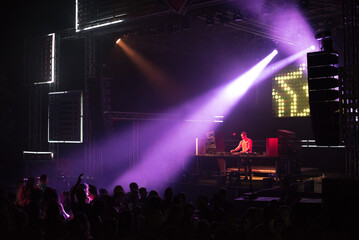 Dj playing techno music on the live night concert in summer