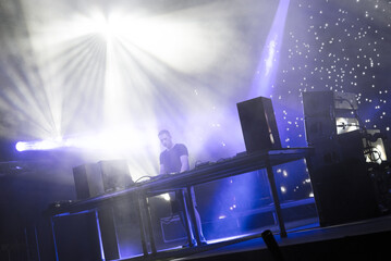Dj playing techno music on the live night concert in summer