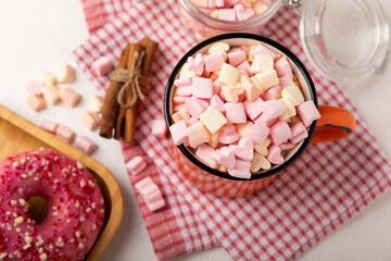 Cocoa drink on texture background. Hot chocolate with small marshmallows and spices. Winter warming drink concept. Space for copy. Space for text