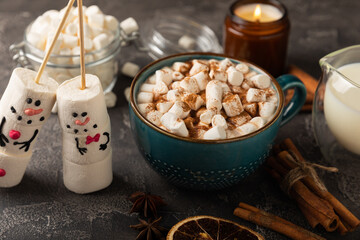 Hot chocolate mug with melted marshmallow snowman.Sweet treat for kids funny marshmallow snowman. Christmas winter holiday decoration. New Year card.Winter hot drink.