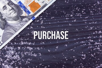 PURCHASE - word (text) on a dark wooden background, money, dollars and snow. Business concept (copy space).