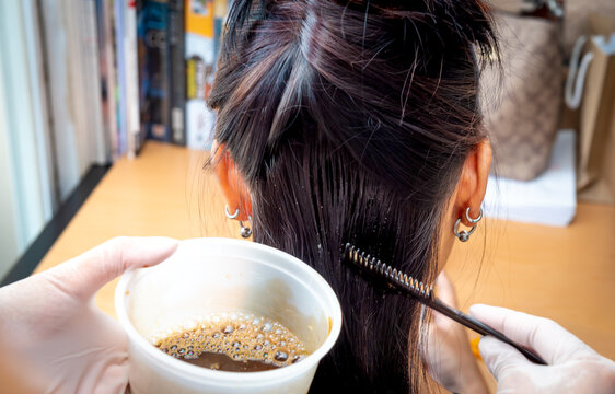 Young Woman Doing Hair Dye At Home.
