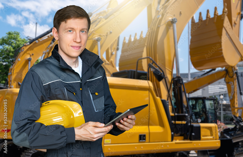 Aufkleber engineer with helmet and digital tablet on the background of construction machines
