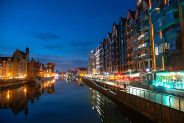 Scenic summer evening panorama of the architectural embankment pier canal river illumination of the Old Town GDANSK, POLAND