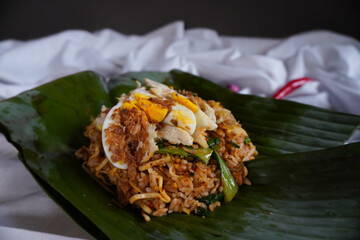 Close Up of Nasi Goreng Bakar or Fried Rice with Banana Leaves Wrapped Isolated on White Background
