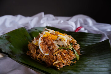 Close Up of Nasi Goreng Bakar or Fried Rice with Banana Leaves Wrapped Isolated on White Background
