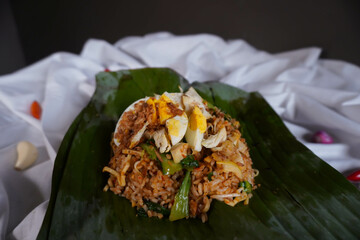 Close Up of Nasi Goreng Bakar or Fried Rice with Banana Leaves Wrapped Isolated on White Background