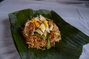 Close Up of Nasi Goreng Bakar or Fried Rice with Banana Leaves Wrapped Isolated on White Background